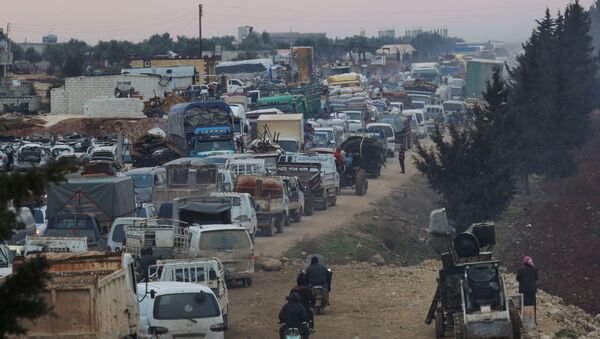 A general view of trucks carrying belongings of displaced Syrians, is pictured in the town of Sarmada in Idlib province, Syria, January 28, 2020 - Sputnik International