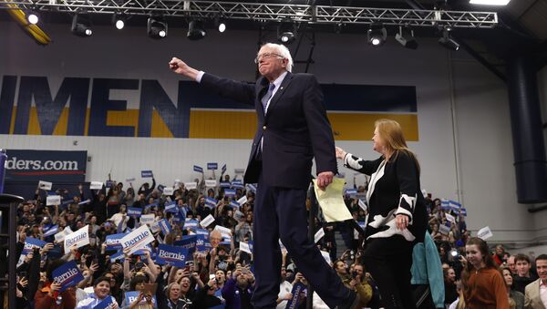 Democratic US presidential candidate Senator Bernie Sanders pumps his fist and is accompanied by his wife Jane O’Meara Sanders as he arrives to speak at his New Hampshire primary night rally in Manchester, N.H., US, February 11, 2020 - Sputnik International