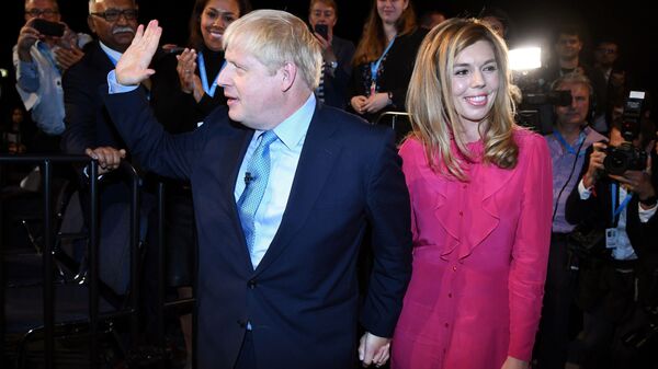Britain's Prime Minister Boris Johnson leaves with his partner Carrie Symonds after delivering his keynote speech to delegates on the final day of the annual Conservative Party conference at the Manchester Central convention complex, in Manchester, north-west England on October 2, 2019 - Sputnik International