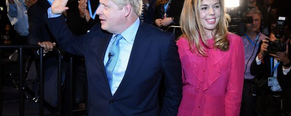 Britain's Prime Minister Boris Johnson leaves with his partner Carrie Symonds after delivering his keynote speech to delegates on the final day of the annual Conservative Party conference at the Manchester Central convention complex, in Manchester, north-west England on October 2, 2019 - Sputnik International