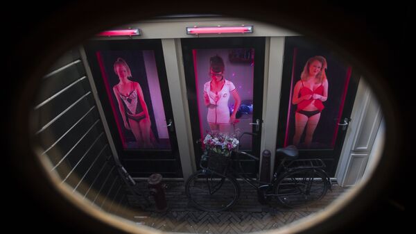 Three video's of women posing as sex workers are projected behind three doors at the Red Light Secrets Museum of Prostitution in Amsterdam - Sputnik International