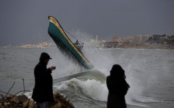Palestinian fishermen ride their boat amid high waves on a windy and rainy day at the sea in Gaza City, Sunday, Feb. 9, 2020.  - Sputnik International
