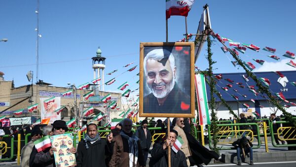 An Iranian man holds a picture of late Iran's Quds Force top commander Qassem Soleimani, during the commemoration of the 41st anniversary of the Islamic revolution in Tehran, Iran February 11, 2020 - Sputnik International