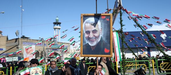 An Iranian man holds a picture of late Iran's Quds Force top commander Qassem Soleimani, during the commemoration of the 41st anniversary of the Islamic revolution in Tehran, Iran February 11, 2020 - Sputnik International