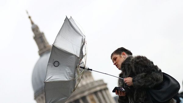 A woman struggles with an umbrella as she walks in front of St Paul's Cathedral during storm Dennis in London, Britain, February 15, 2020.  - Sputnik International