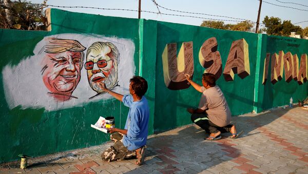 A man applies finishing touches to paintings of U.S. President Donald Trump and India's Prime Minister Narendra Modi on a wall as part of a beautification along a route that Trump and Modi will be taking during Trump's upcoming visit, in Ahmedabad, India, February 17, 2020 - Sputnik International