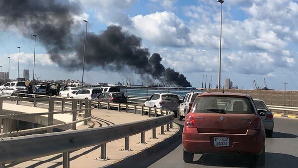 A cloud of smoke rises from the port of Tripoli after an attack in Libya on 18 February 2020 - Sputnik International
