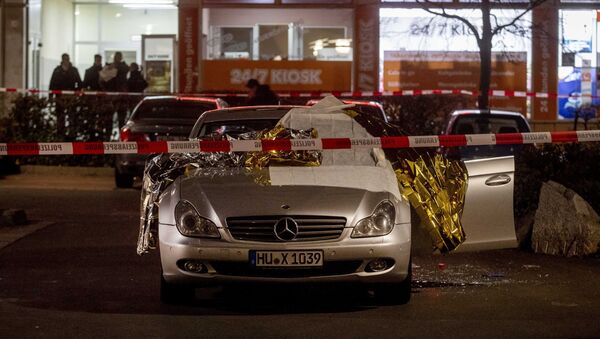 A car with dead bodies stands in front of a bar in Hanua, Germany Thursday, Feb. 20, 2020. German police say several people were shot to death in the city of Hanau on Wednesday evening - Sputnik International
