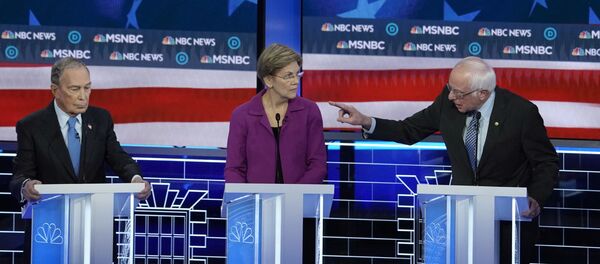 Senator Bernie Sanders (R) speaks to former New York City Mayor Michael Bloomberg (L) about the non-disclosure agreements at Bloomberg's company as Senator Elizabeth Warren listens at the ninth Democratic 2020 U.S. Presidential candidates debate at the Paris Theater in Las Vegas, Nevada, U.S., February 19, 2020. Senator Bernie Sanders (R) speaks to former New York City Mayor Michael Bloomberg (L) about the non-disclosure agreements at Bloomberg's company as Senator Elizabeth Warren listens at the ninth Democratic 2020 U.S. Presidential candidates debate at the Paris Theater in Las Vegas, Nevada, U.S., February 19, 2020. - Sputnik International