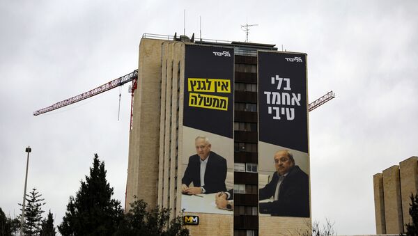 A giant poster showing retired Israeli army general and leader of the Blue and White Israeli electoral alliance Benny Gantz (L) and Arab Israeli member of the Joint List Ahmad Tibi, with a writing in Hebrew that reads:Without Ahmed Tibi, Gantz doesn't have a government, covers the wall of a building in Jerusalem on February 14, 2020.  - Sputnik International