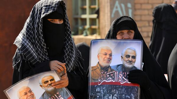 Iraqi women hold portraits of Iran's late top general Qasem Soleimani (R) and Iraqi paramilitary commander Abu Mahdi al-Muhandis, killed in a US drone strike near Baghdad airport last month, during a rally called by controversial cleric Moqtada Sadr against the US' presence in Iraq and calling to separate the genders in rallies, on February 14, 2020 in the central city of Kufa - Sputnik International