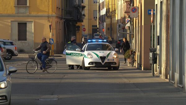 A police car is seen in the village of Codogno after officials told residents to stay home and suspend public activities as 14 cases of coronavirus are confirmed in northern Italy, in this still image taken from video in the province of Lodi, Italy, February 21, 2020 - Sputnik International