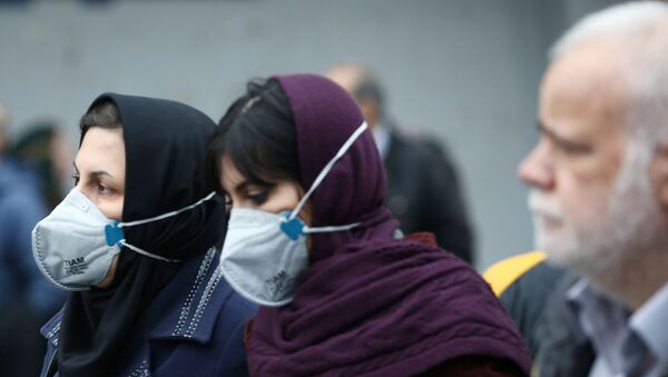 Iranian women wearing protective masks to prevent contracting a coronavirus as they walk at Grand Bazaar in Tehran, Iran February 20, 2020. - Sputnik International