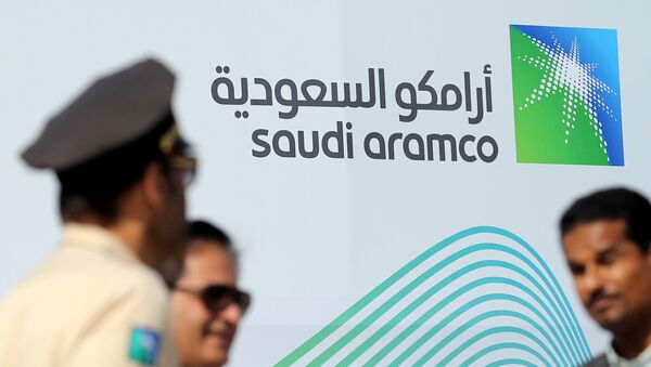 The logo of Aramco is seen as security personnel stand before the start of a press conference by Aramco at the Plaza Conference Center in Dhahran, Saudi Arabia November 3, 2019 - Sputnik International
