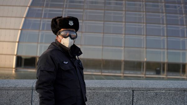 A security guard wearing goggles and a face mask is seen near the National Centre for the Performing Arts, following an outbreak of the novel coronavirus in the country, in Beijing, China February 22, 2020. - Sputnik International