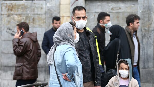 Iranian family wear protective masks to prevent contracting a coronavirus, as they stand at Grand Bazaar in Tehran, Iran February 20, 2020.  - Sputnik International