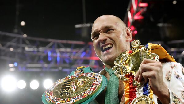 Tyson Fury poses with his belts during a press conference after the fight with Deontay Wilder for the WBC heavyweight title at the Grand Garden Arena at MGM Grand, Las Vegas, United States, February 22, 2020  - Sputnik International