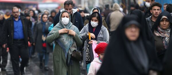 Iranian women wear protective masks to prevent contracting a coronavirus, as they walk at Grand Bazaar in Tehran, Iran February 20, 2020. - Sputnik International