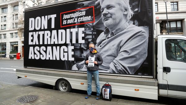 A pro-Assange demonstrator stands outside the Australian High Commission as they gather to protest against the extradition of Julian Assange, in London, Britain February 22, 2020 - Sputnik International