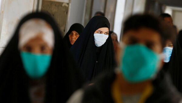 Iraqi people wear protective masks, following the outbreak of the new coronavirus, at a hospital in Najaf, Iraq February 23, 2020 - Sputnik International