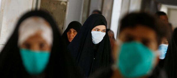 Iraqi people wear protective masks, following the outbreak of the new coronavirus, at a hospital in Najaf, Iraq February 23, 2020 - Sputnik International