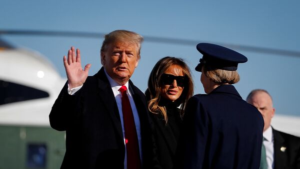 U.S. President Donald Trump waves as he and first lady Melania Trump board Air Force One to depart Washington for travel to India at Joint Base Andrews, Maryland, U.S., February 23, 2020. - Sputnik International