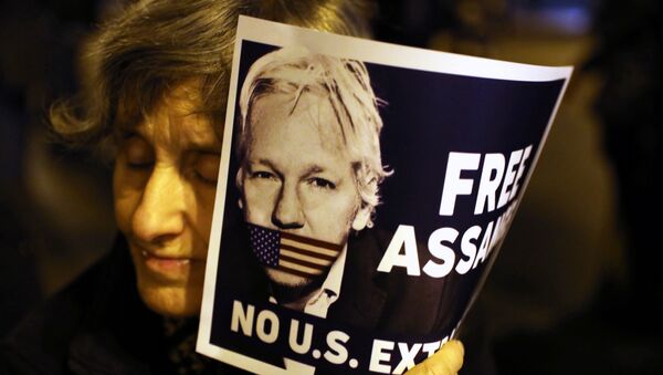 A demonstrator holds a placard in support of WikiLeaks founder Julian Assange during a protest against his extradition to the United States, in Barcelona, Spain February 24, 2020. - Sputnik International