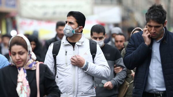 Iranian men wearing protective masks to prevent contracting a coronavirus walk at Grand Bazaar in Tehran, Iran February 20, 2020 - Sputnik International