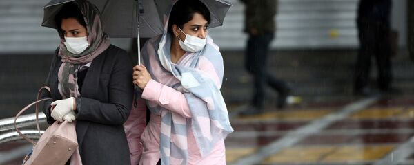 Iranian women wear protective masks to prevent contracting coronavirus, as they walk in the street in Tehran, Iran February 25, 2020. Iranian women wear protective masks to prevent contracting coronavirus, as they walk in the street in Tehran, Iran February 25, 2020. - Sputnik International