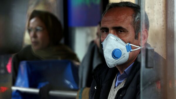 An Iranian man wears a protective masks to prevent contracting coronavirus, as he sits in the bus in Tehran, Iran 25 February 2020. - Sputnik International