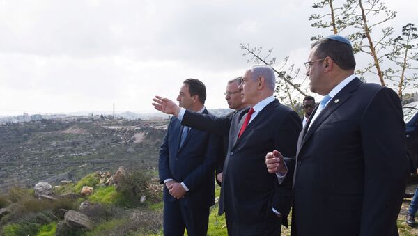 Israeli Prime Minister Benjamin Netanyahu points to the area of Israeli settlement of Har Homa, located in an area of the Israeli-occupied West Bank, that Israel annexed to Jerusalem after the region's capture in the 1967 Middle East war, February 20, 2020 - Sputnik International