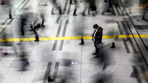 A man wearing a protective face mask, following an outbreak of the coronavirus, stands at the Shinagawa station in Tokyo, Japan, February 28, 2020. REUTERS/Athit Perawongmetha - Sputnik International