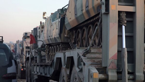 Turkish military vehicles enter the Bab al-Hawa crossing at the Syrian-Turkish border, in Idlib governorate, Syria, February 9, 2020. REUTERS/Khalil Ashawi - Sputnik International