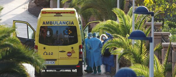 A tourist affected by coronavirus is transferred to a hospital from the hotel H10 Costa Adeje Palace, which is on lockdown after novel coronavirus has been confirmed in Adeje, on the Spanish island of Tenerife, Spain, February 29, 2020. REUTERS/Borja Suarez - Sputnik International