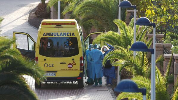A tourist affected by coronavirus is transferred to a hospital from the hotel H10 Costa Adeje Palace, which is on lockdown after novel coronavirus has been confirmed in Adeje, on the Spanish island of Tenerife, Spain, February 29, 2020. REUTERS/Borja Suarez - Sputnik International