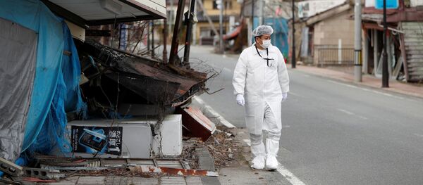 Yuji Onuma, an evacuee from Futaba Town near tsunami-crippled Fukushima Daiichi nuclear power plant, walks next to a collapsed shop on the street in Futaba Town, inside the exclusion zone around the plant, Fukushima Prefecture, Japan February 20, 2020 Yuji Onuma, an evacuee from Futaba Town near tsunami-crippled Fukushima Daiichi nuclear power plant, walks next to a collapsed shop on the street in Futaba Town, inside the exclusion zone around the plant, Fukushima Prefecture, Japan February 20, 2020 - Sputnik International