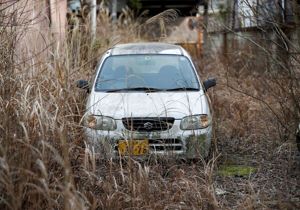 An abandoned car is seen inside the exclusion zone around the tsunami-crippled Fukushima Daiichi nuclear power plant in Futaba Town, Fukushima Prefecture, Japan February 20, 2020 - Sputnik International