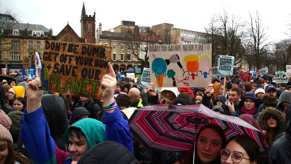 Young demonstrators hold placards as they attend a Youth Strike 4 Climate protest in Bristol, south west England on February 28, 2020.  - Sputnik International