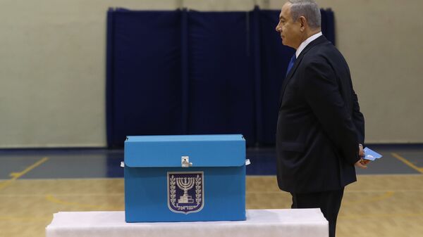 Israeli Prime Minister Benjamin Netanyahu prepares to cast his ballot during the Israeli legislative elections at a polling station in Jerusalem, Monday, March 2, 2020. Israelis have begun voting in the country's unprecedented third election in less than a year. - Sputnik International