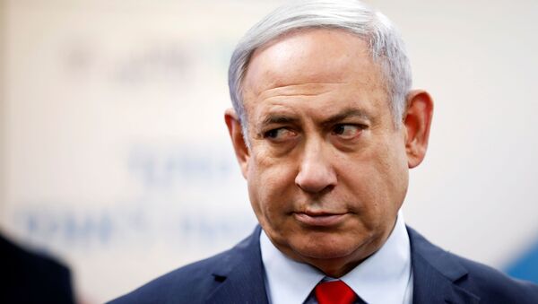 Israeli Prime Minister Benjamin Netanyahu looks on as he delivers a statement during his visit at the Health Ministry national hotline, in Kiryat Malachi, Israel - Sputnik International