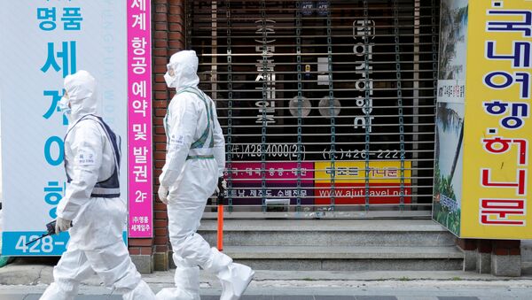 South Korean soldiers wearing protective gear walk past a closed shop while they sanitize a street after the rapid rise in confirmed cases of the novel coronavirus disease of COVID-19 in Daegu, South Korea March 2, 2020 - Sputnik International