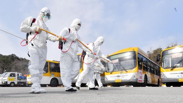 Employees from a disinfection service company sanitise a bus garage in Gwangju, South Korea, 3 March 2020.  - Sputnik International
