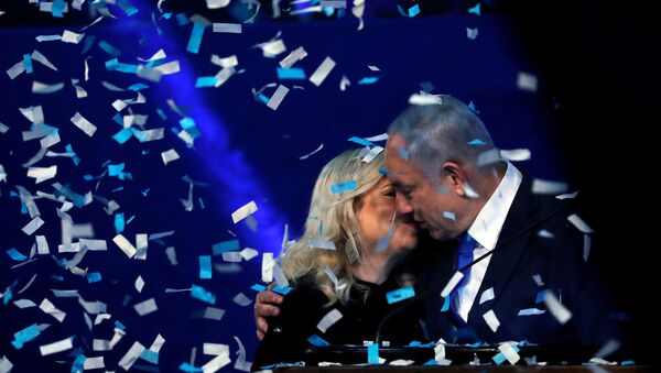 Confetti falls as Israeli Prime Minister Benjamin Netanyahu kisses his wife Sara after speaking to supporters following the announcement of exit polls in Israel's election at his Likud party headquarters in Tel Aviv, Israel March 3, 2020. - Sputnik International