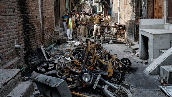Police photograph burnt out properties owned by Muslims in a riot affected area following clashes between people demonstrating for and against a new citizenship law in New Delhi, India, March 2, 2020 - Sputnik International