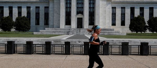 A woman jogs past the Federal Reserve building in Washington, U.S., July 16, 2018 - Sputnik International
