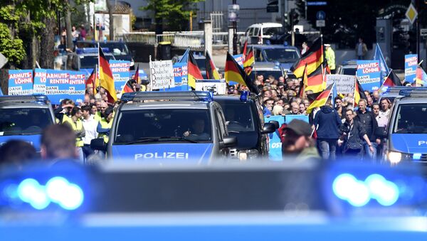 AfD supporters walk accompanied by police cars in Erfurt, Germany, Wednesday, May 1, 2019. The Alternative for Germany launches its European parliament election campaign in the eastern city of Erfurt. - Sputnik International