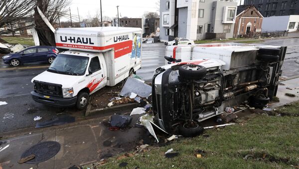 Damaged trucks sit on a sidewalk as well as the street following a deadly tornado, Tuesday, March 3, 2020, in Nashville, Tenn. Tornadoes ripped across Tennessee early Tuesday, shredding buildings and killing multiple people. - Sputnik International