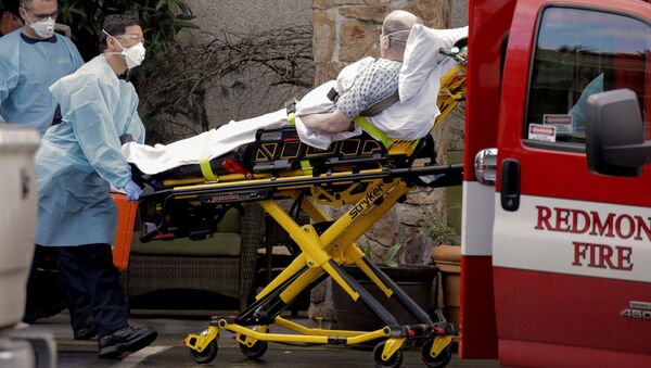 Medics transport a man on a stretcher into an ambulance at the Life Care Center, a long-term care facility linked to several confirmed coronavirus cases, in Kirkland, Washington, U.S. March 3, 2020 - Sputnik International