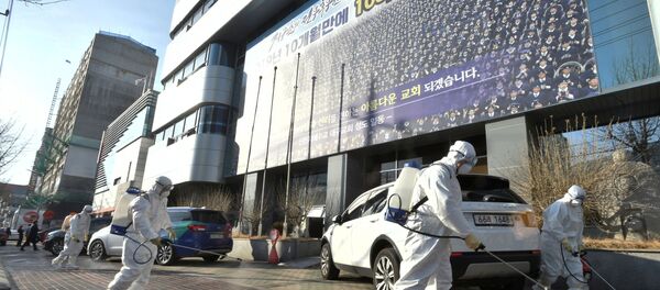Workers from a disinfection service company sanitize a street in front of a branch of the Shincheonji Church of Jesus the Temple of the Tabernacle of the Testimony where a woman known as Patient 31 attended a service in Daegu, South Korea, February 19, 2020 - Sputnik International