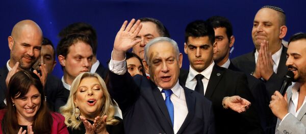 Israeli Prime Minister Benjamin Netanyahu stands next to his wife Sara as he waves to supporters following the announcement of exit polls in Israel's election at his Likud party headquarters in Tel Aviv, Israel March 3, 2020 Israeli Prime Minister Benjamin Netanyahu stands next to his wife Sara as he waves to supporters following the announcement of exit polls in Israel's election at his Likud party headquarters in Tel Aviv, Israel March 3, 2020 - Sputnik International